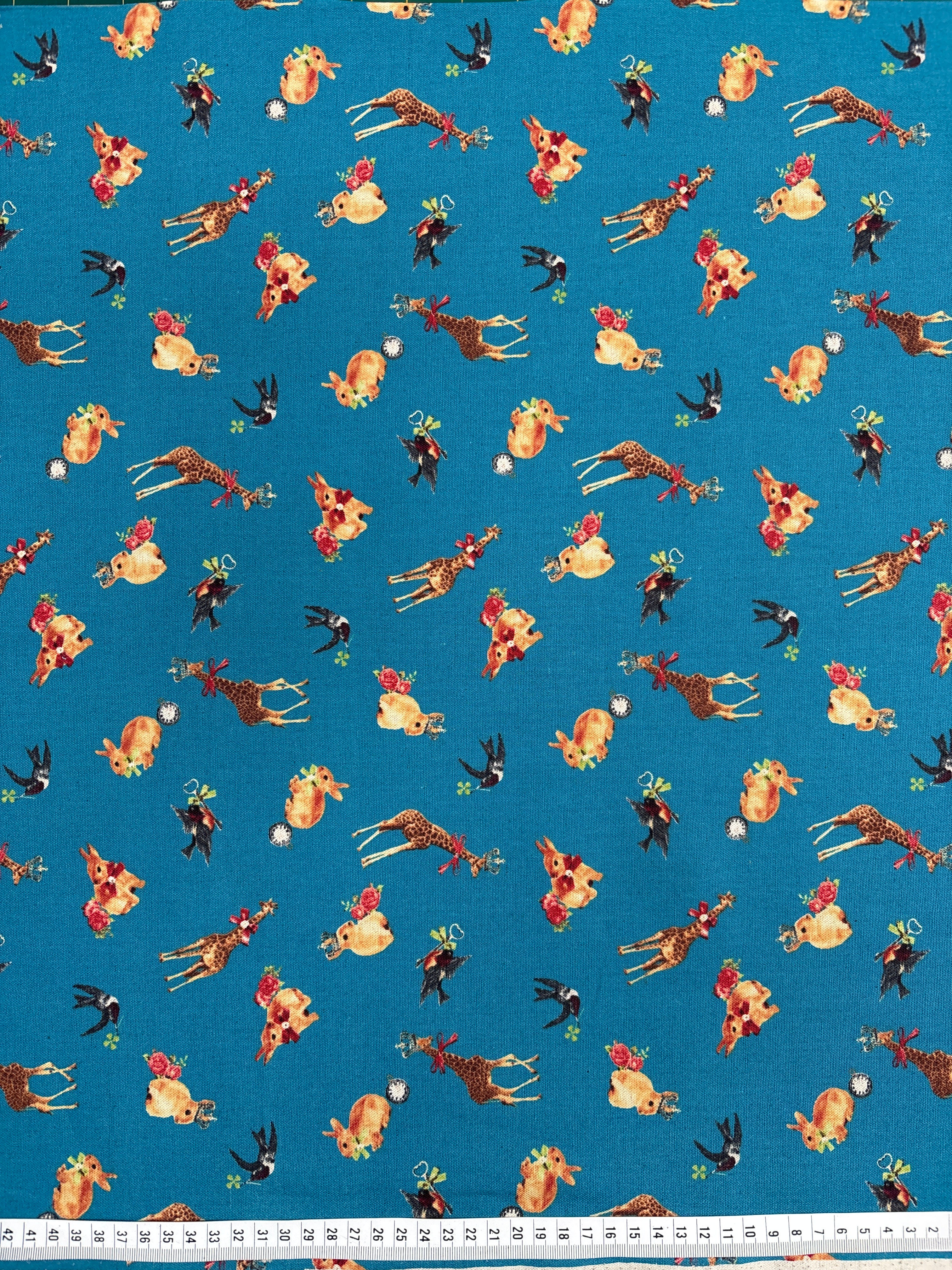 Patterned fabric with animals and flowers on a blue background