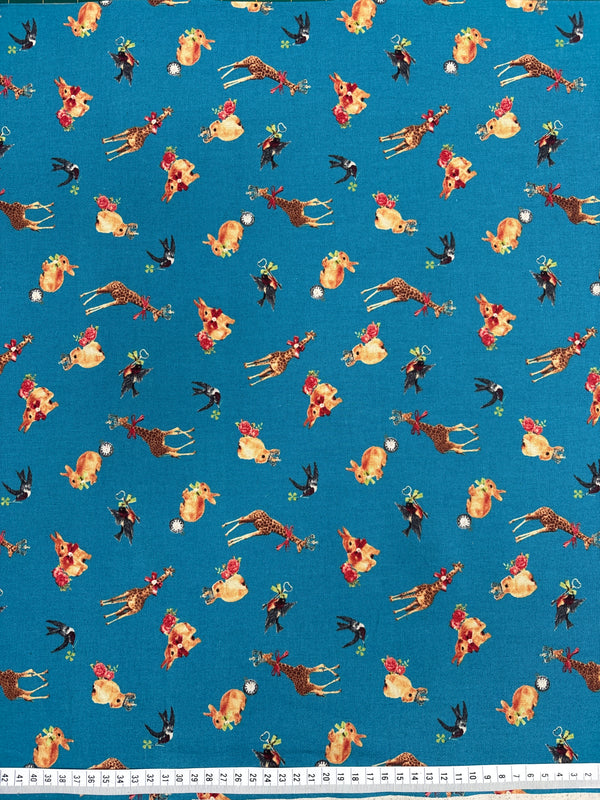 Patterned fabric with animals and flowers on a blue background