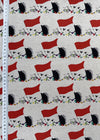 Fabric with a pattern of red flags and black and white shapes on a white background, with a ruler for scale.