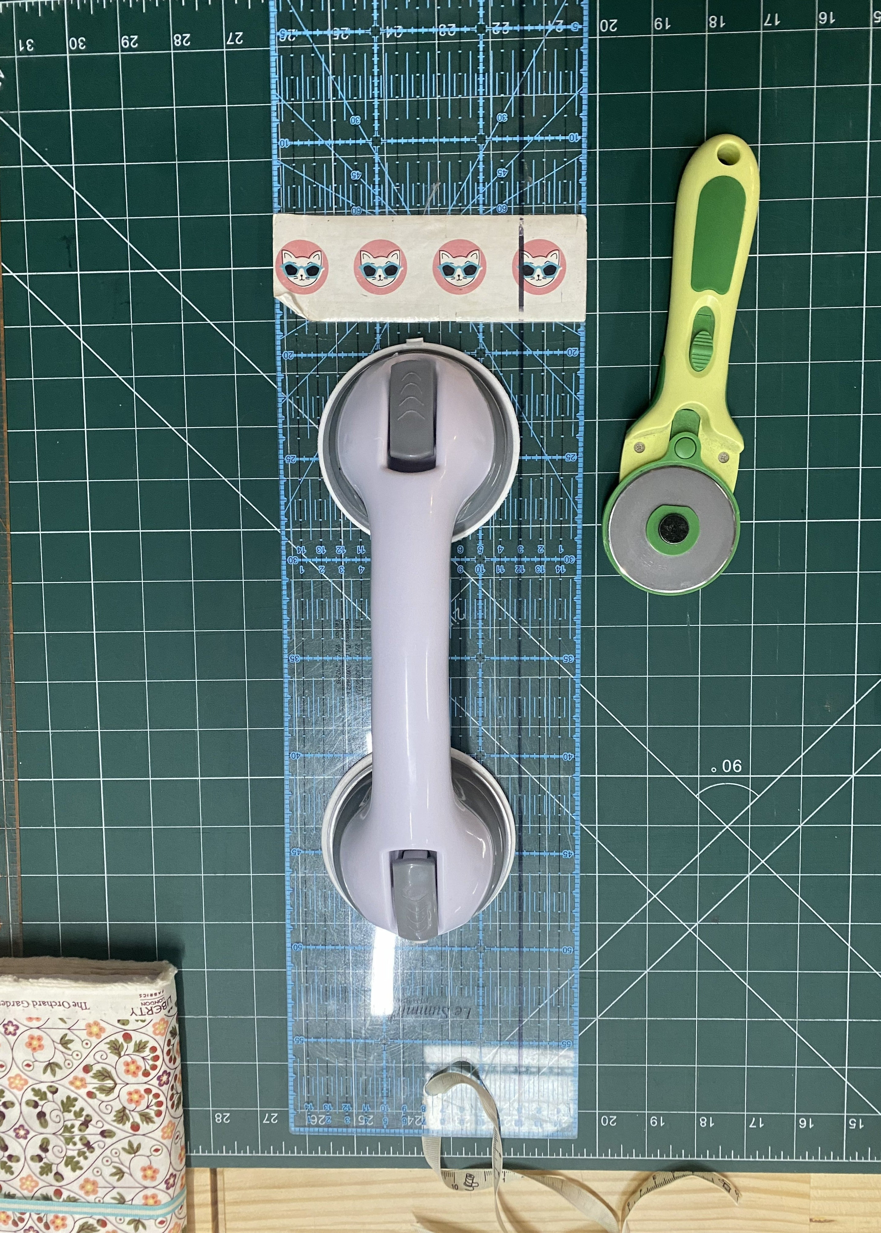 Suction grip handle aid for cutting fabric.