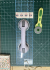 Suction grip handle aid for cutting fabric.
