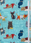 Fabric with a pattern of cartoon cats on a blue background