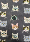 Pattern of stylized cat faces on a dark background