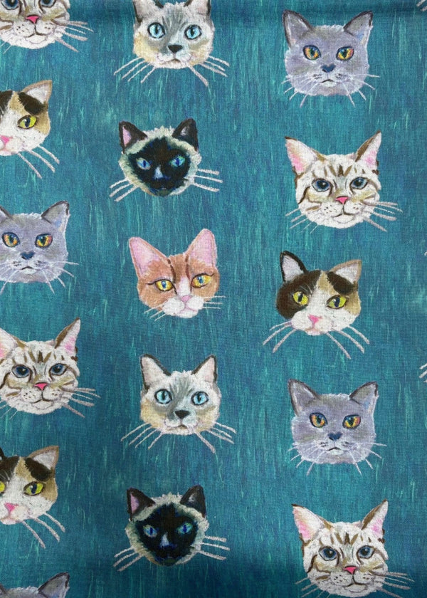 Pattern of cat faces on a blue background