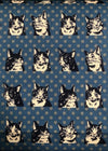 Pattern of black and white cat faces on a blue background with white polka dots