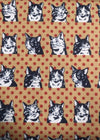 Pattern of black cat faces on a brown background with red polka dots