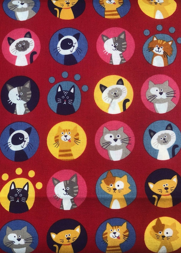 Pattern of cartoon cats in various colors on a red background